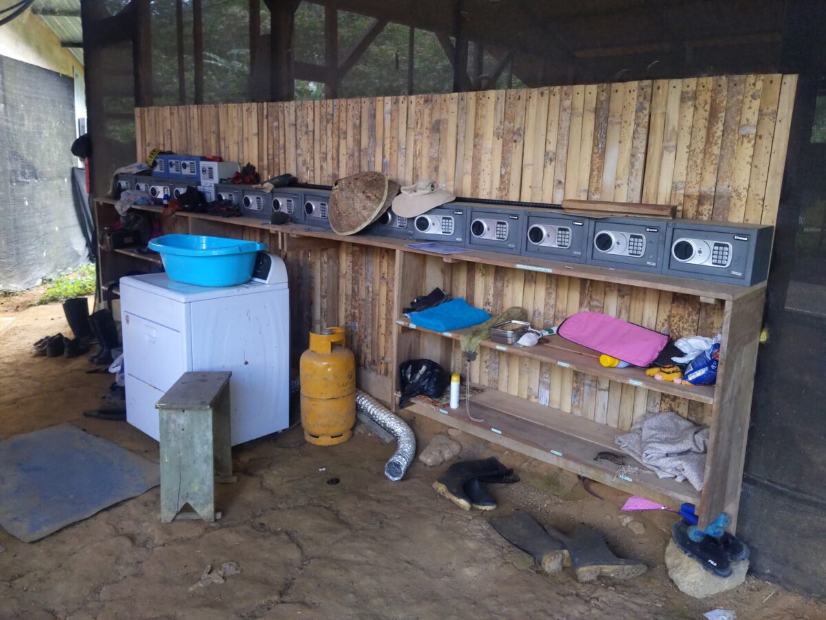 Photo of a shelf cluttered with various items. On the top of the shelf is an array of twenty (20) safes