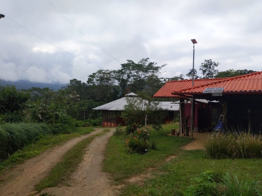 Photo shows a small unfolded solar panel ontop of a 1-story roof