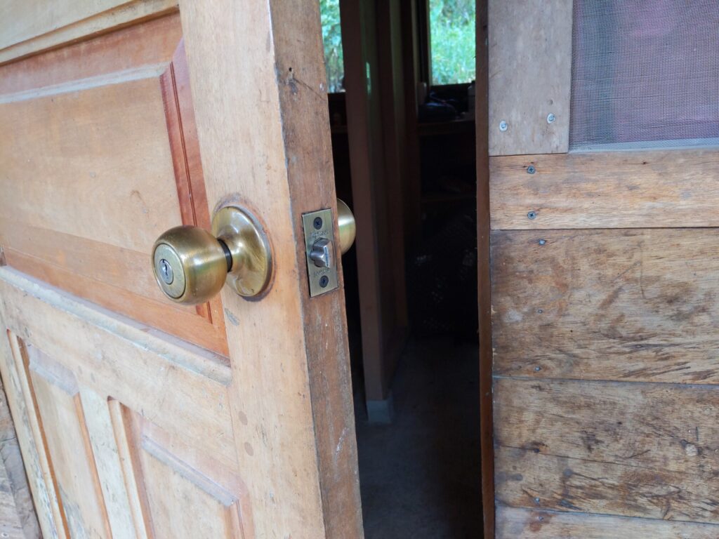 Photo of the outside of a door showing a knob lock and the keyed cylinder